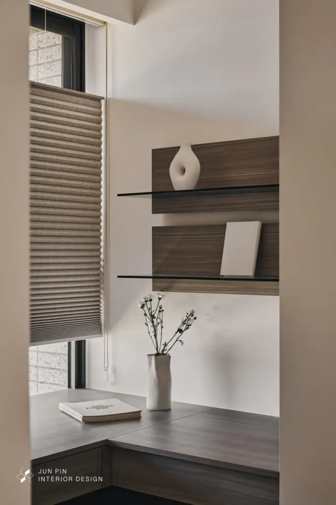 多功能更衣書房： 以灰玻與木質打造 L 型衣櫃，保持光線穿透力。灰玻門片在燈光關閉時具隱蔽感，開啟時則呈現精品展示櫃的精緻。